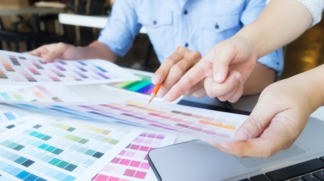 Graphic design and color swatches and pens on a desk. Architectural drawing with work tools and accessories.