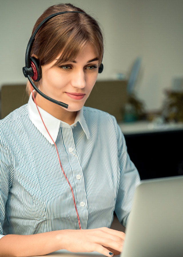 Woman using laptop and Addasound EPIC 512 USB headset