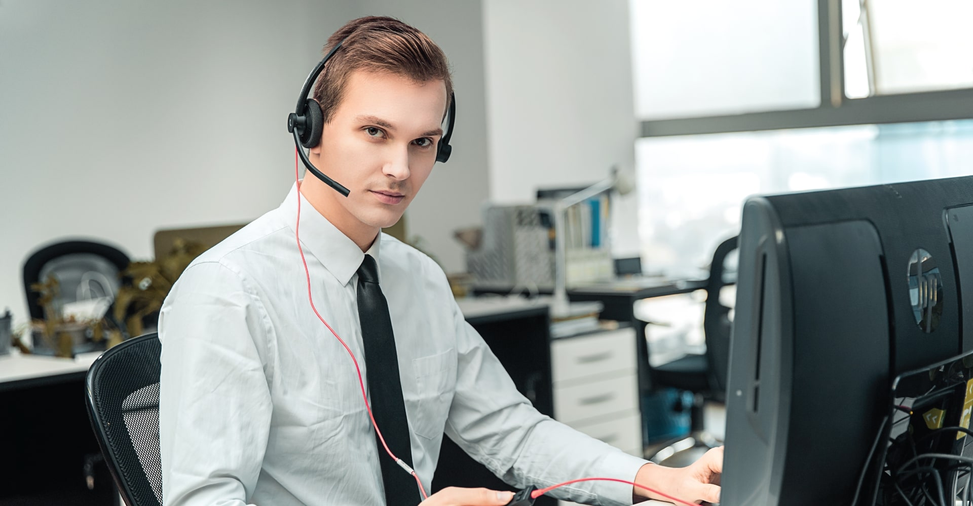 Office employee using entry-level Addasound EPIC 302 USB headset