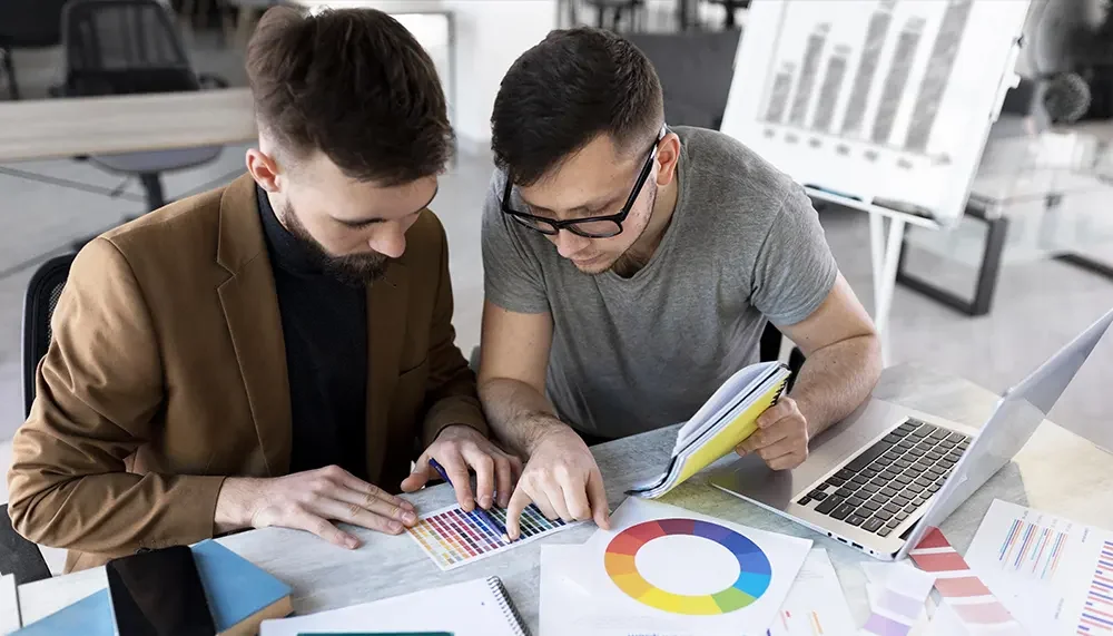 men-analyzing-graph-together-work